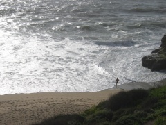 naked man by the ocean